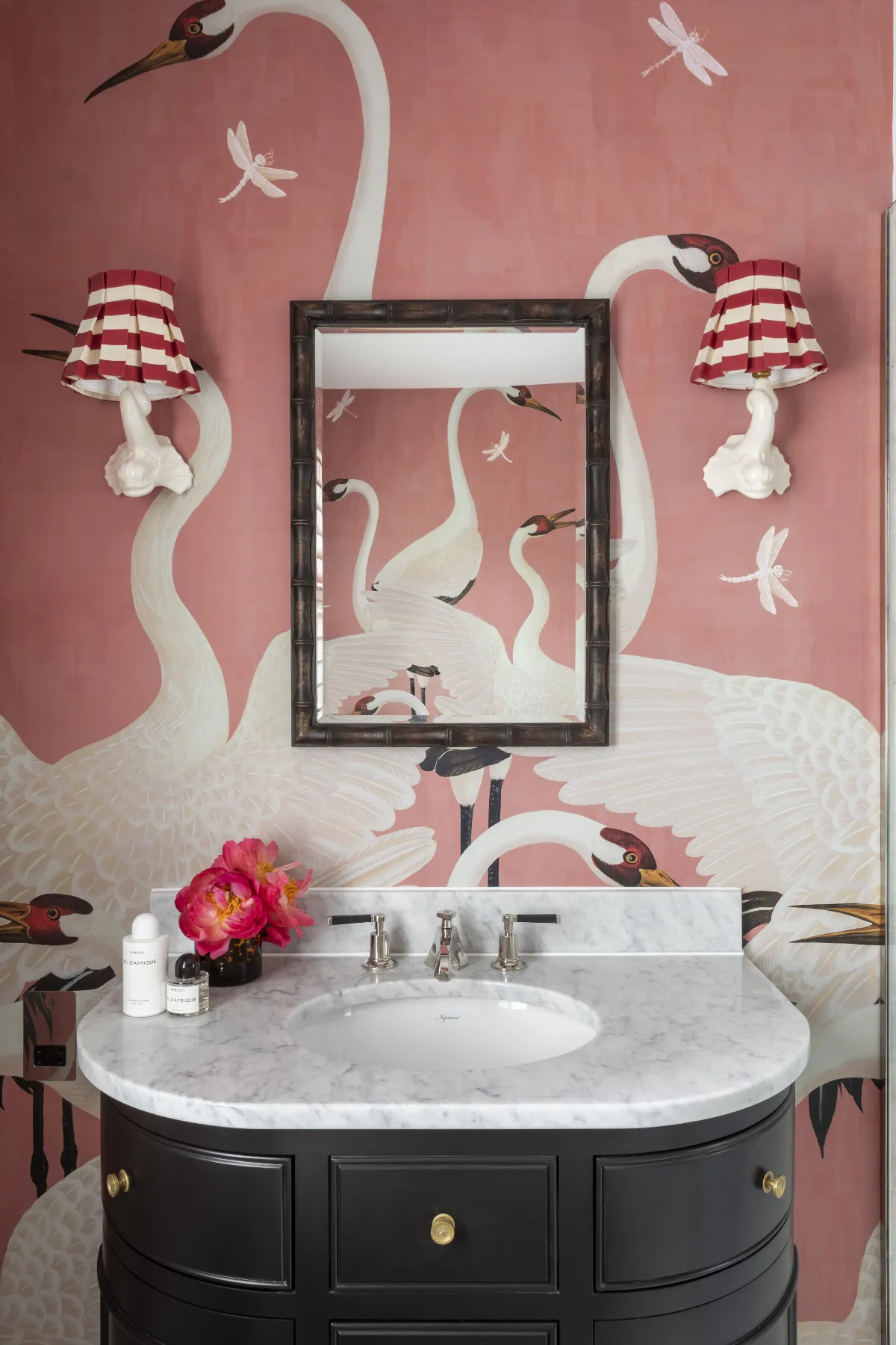 Craning herons and striped sconces across rose-pink walls